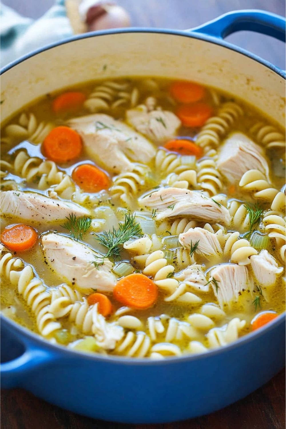 Image of chicken noodle soup in a blue bowl