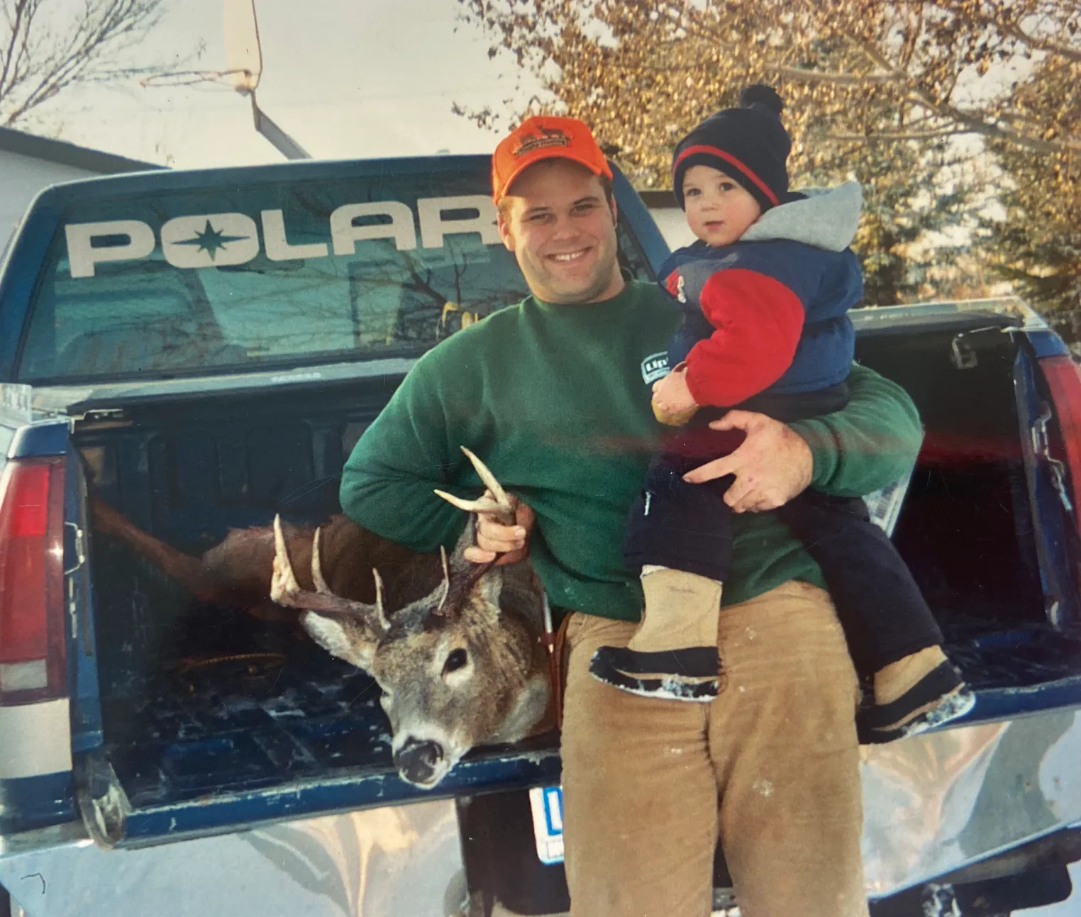 image of man with a buck and a baby