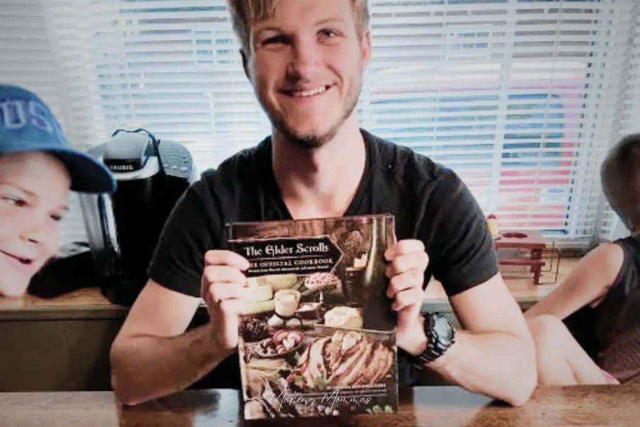 an image of a teenager holding The Elder Scrolls Cookbook