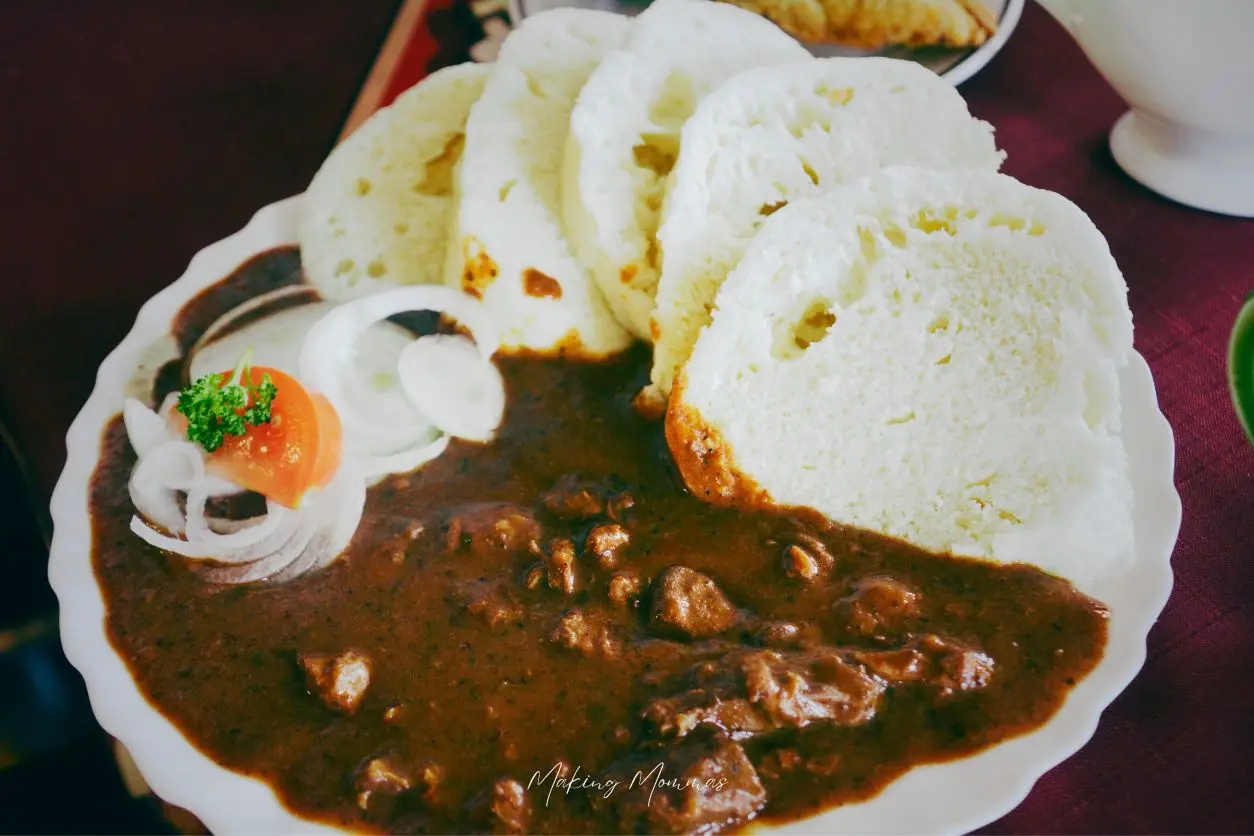 image of stew on a plate with slices of bread