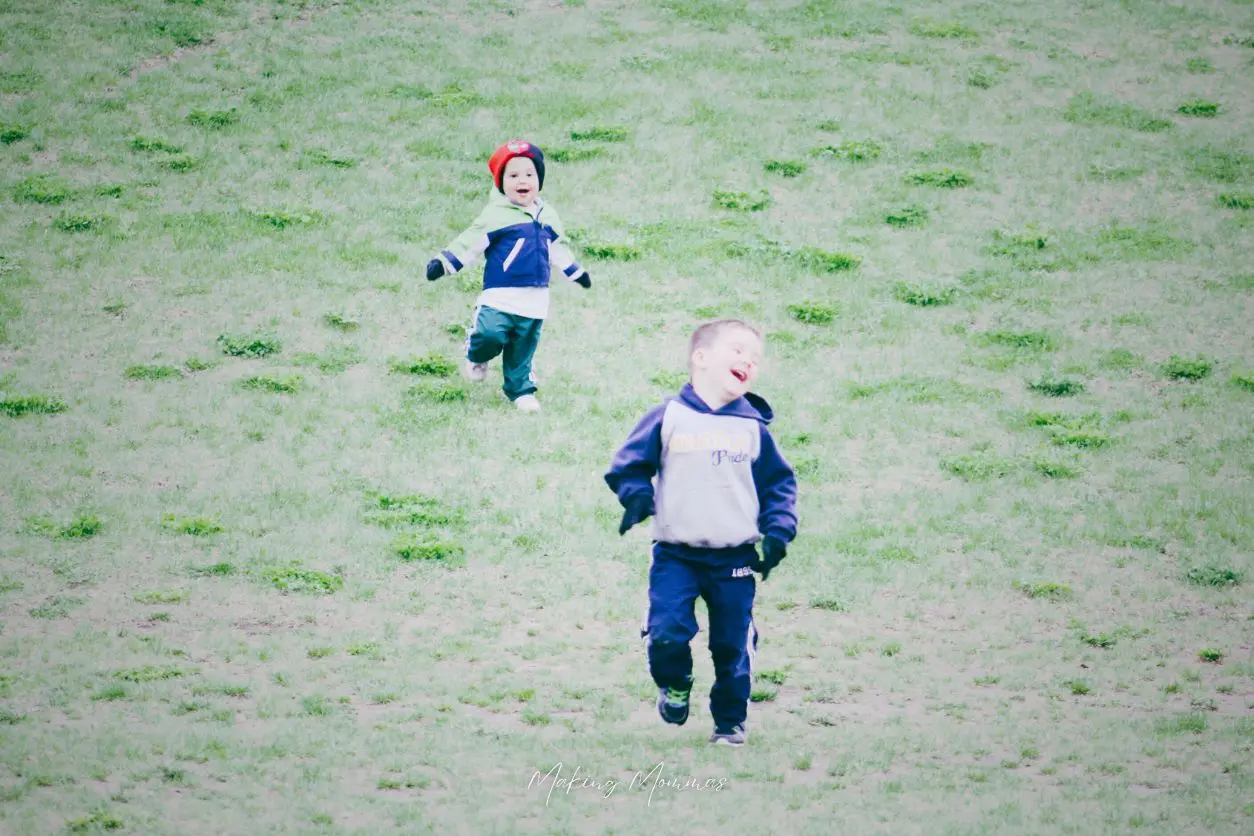 image of two little boys running down a hill