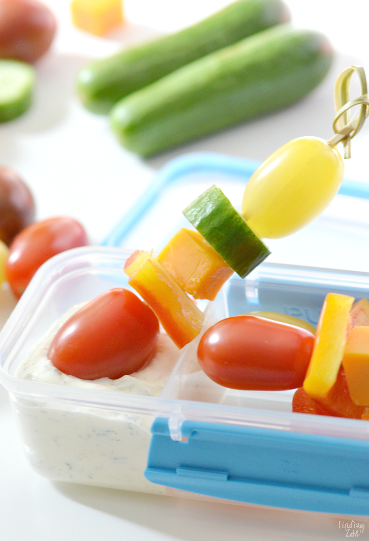 image of a veggie kabob in a bento box being dipped in ranch