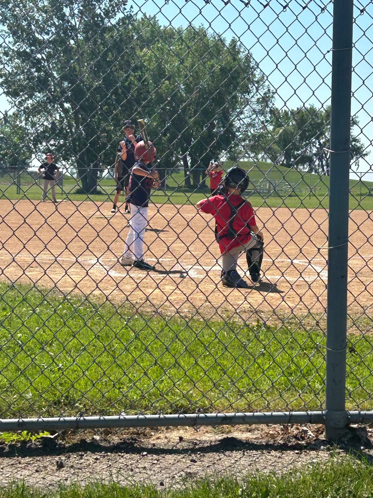 image of boy playing baseball with other children