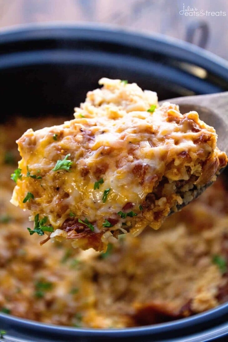 image of a spoonful of turkey crock pot breakfast casserole with the crock pot in the background