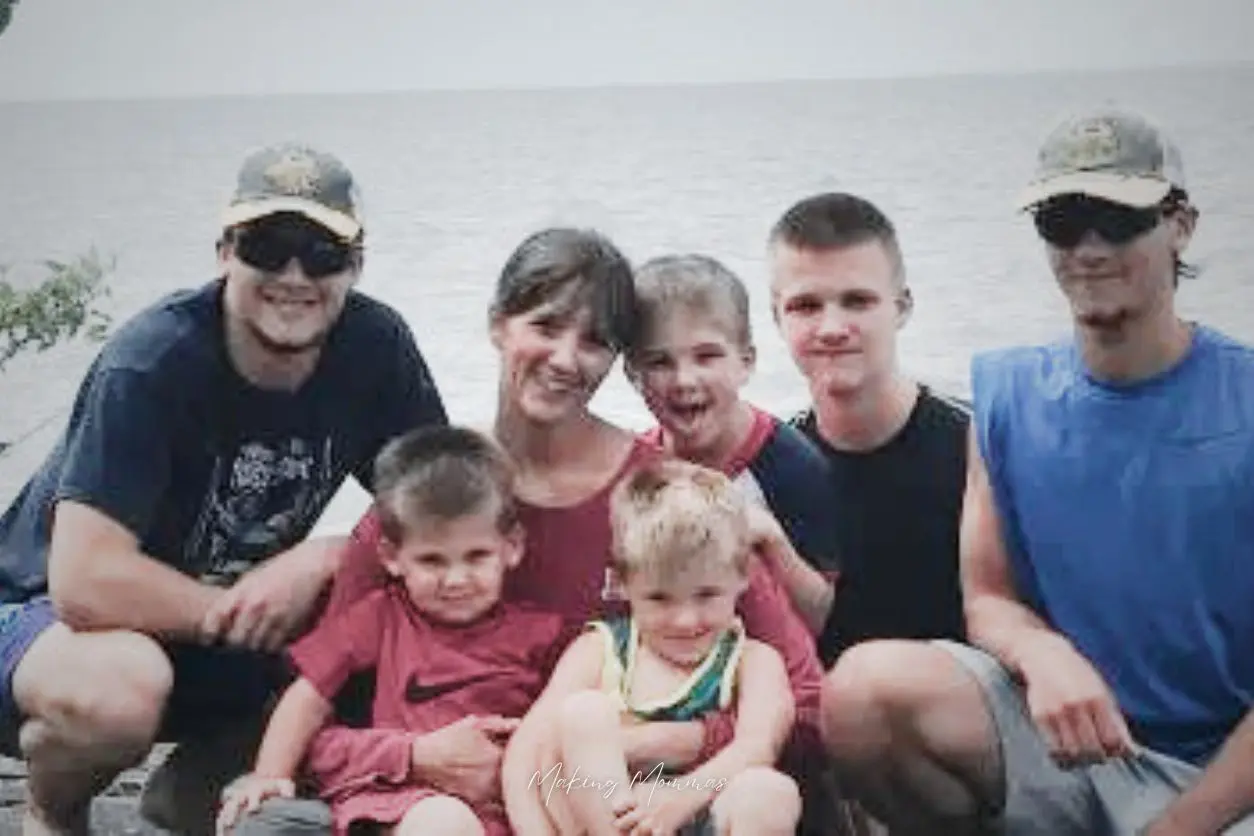 image of a mom and six boys in front of a lake