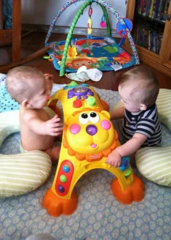 image of twins playing with toy