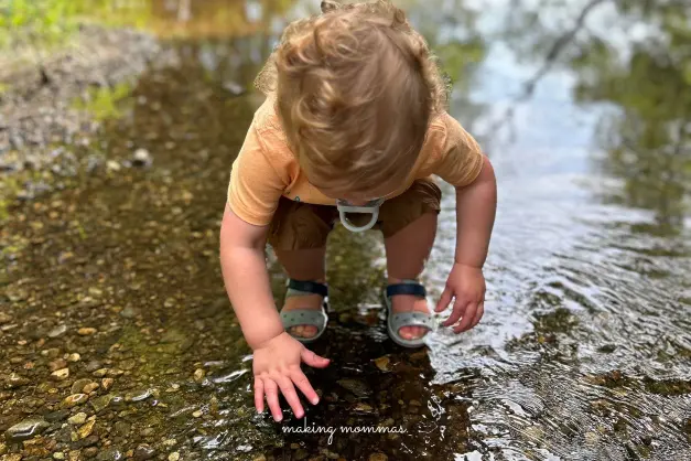 a baby playing in the river