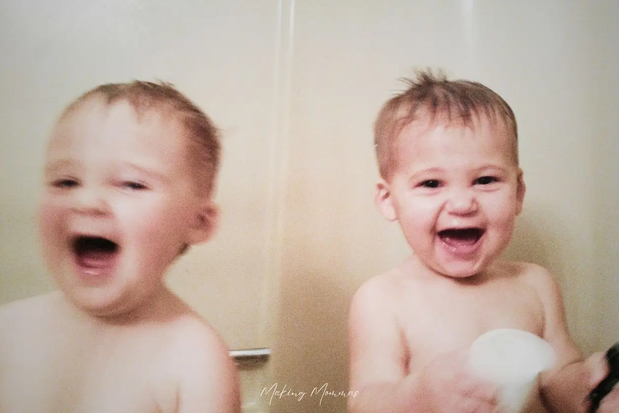 Image of two small boys laughing in the bath tub