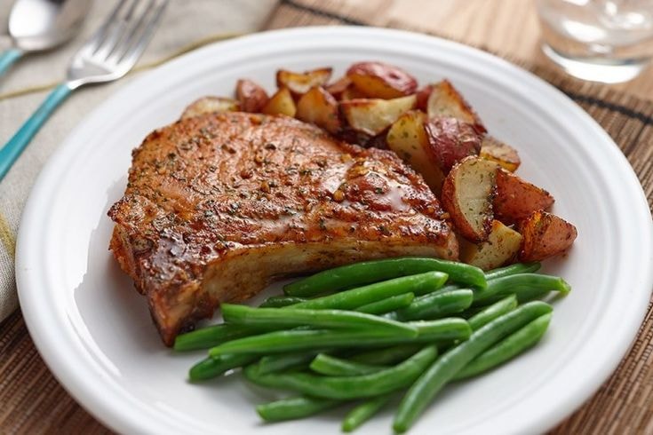 image of ranch pork chops, baby potatoes and string beans on a plate