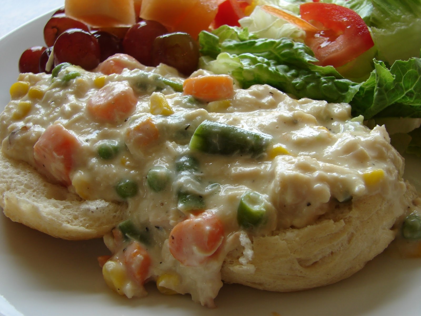 Image of chicken pot pie filling over biscuits