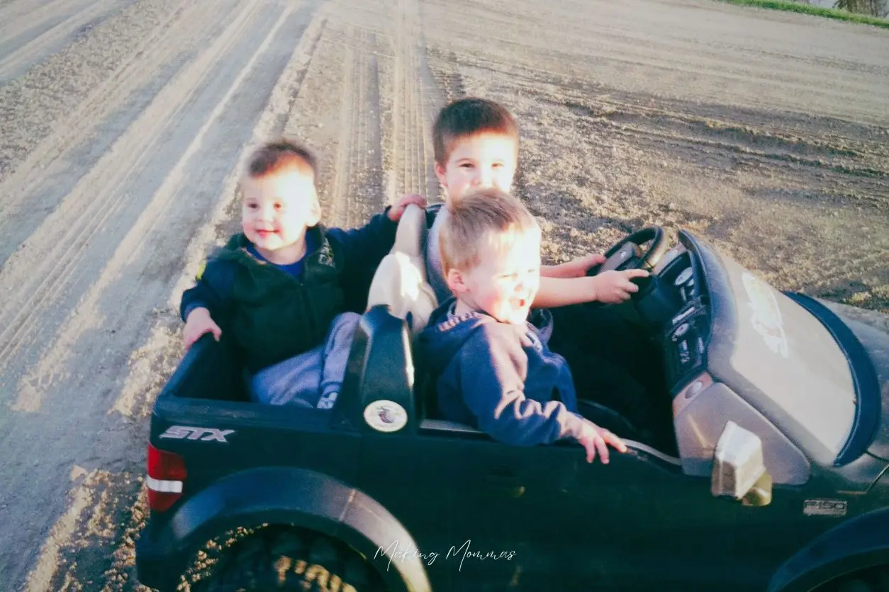 image of three little boys in a little truck