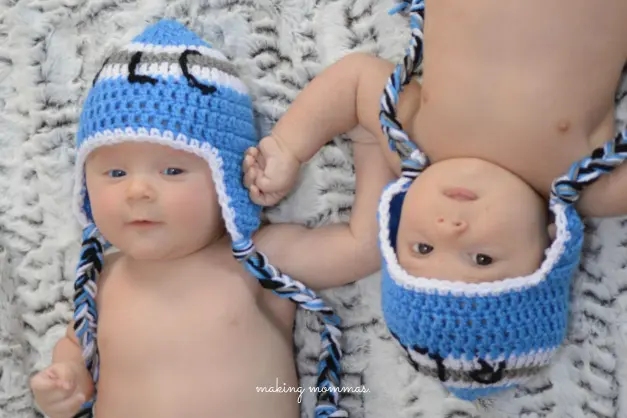 image of twin boys in blue stocking caps