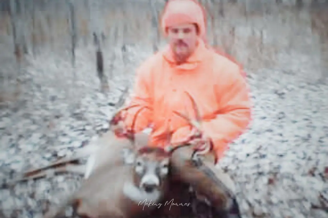 image of a young man holding his buck