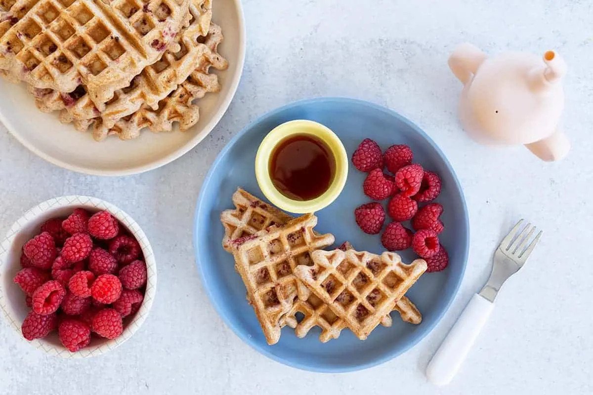 image of waffles with raspberries on a plate