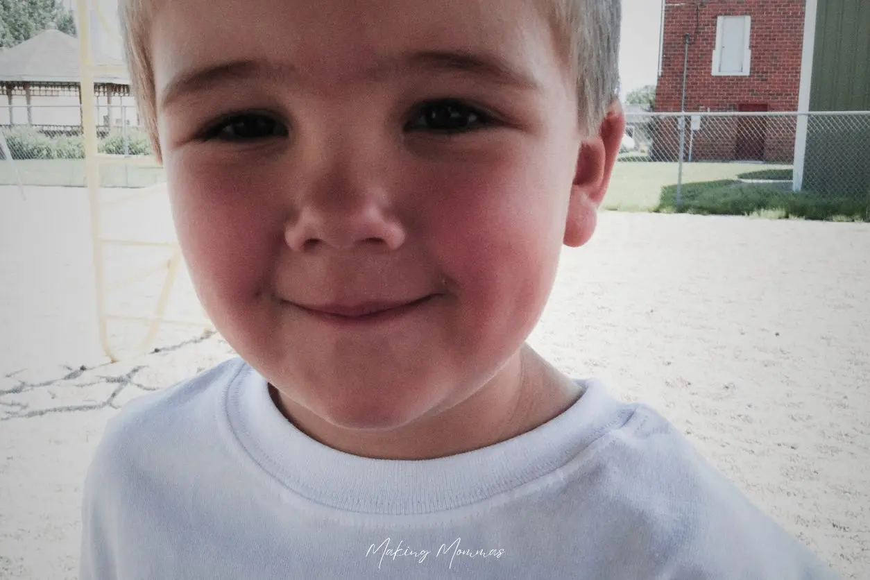 image of a little boy smiling at the park