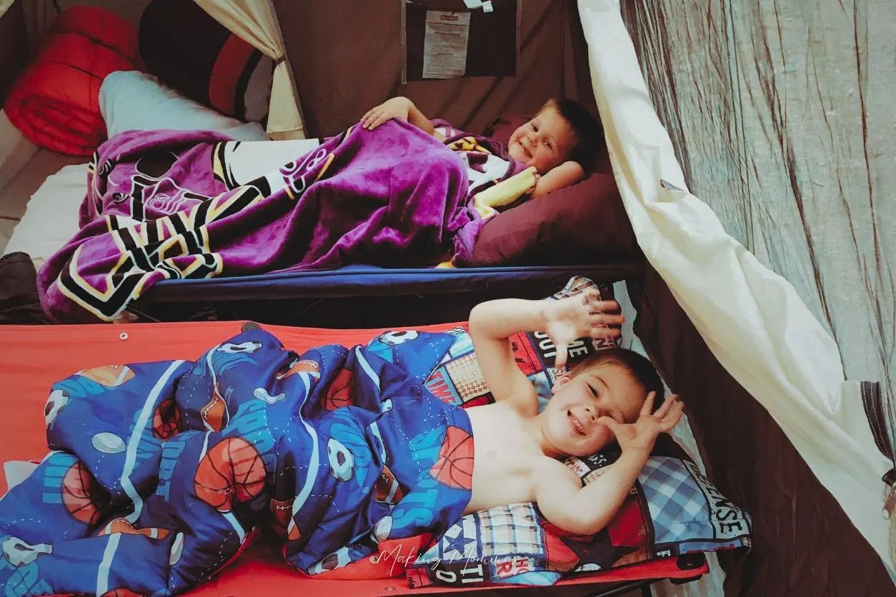image of three boys camping out in a tent