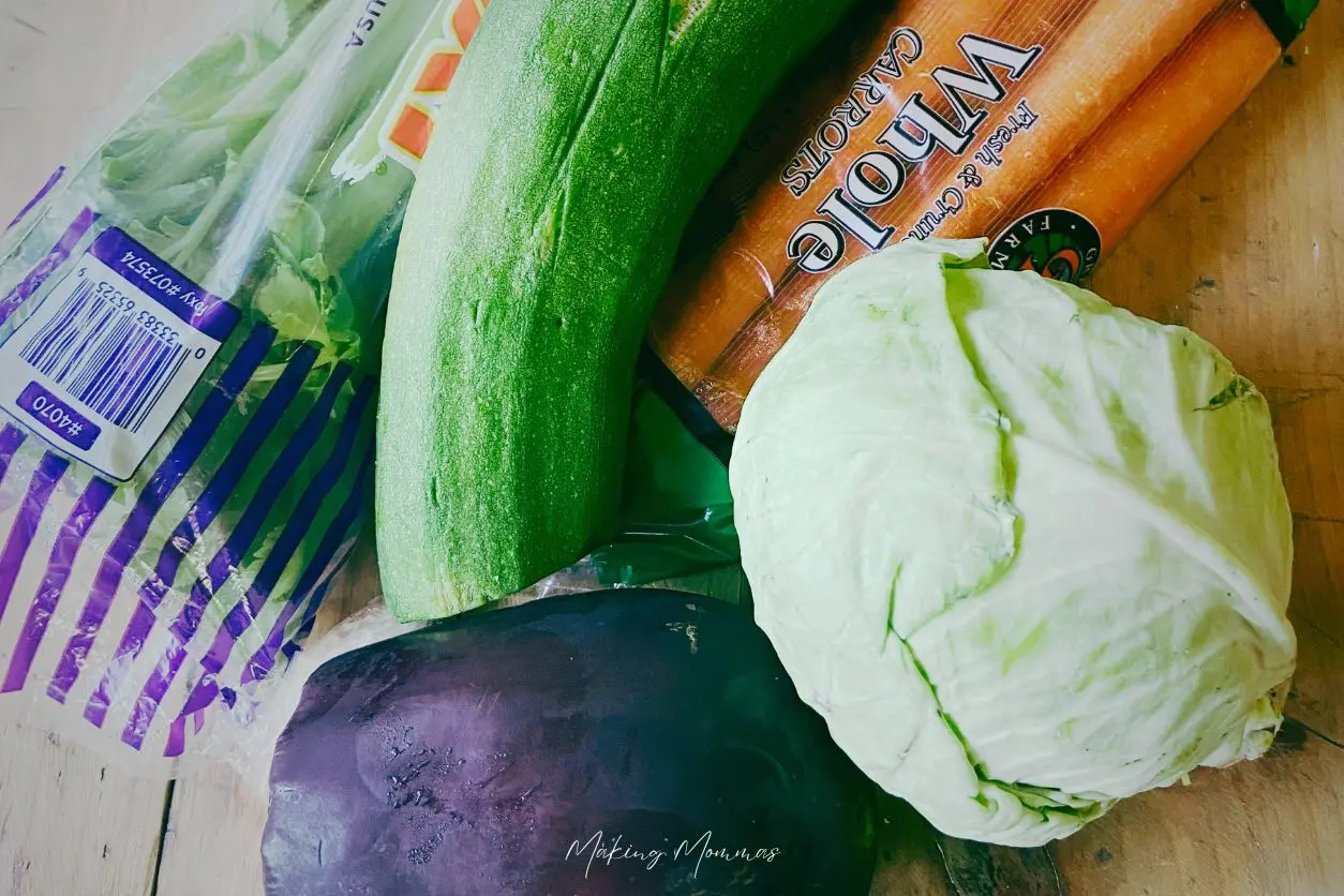 image of celery, zucchini, cabbage, carrots, and a purple veggie on a table