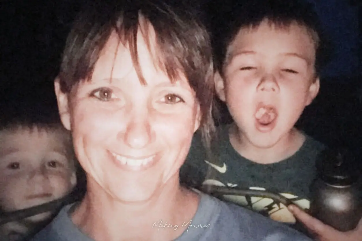 image of a mom and two little boys taking a selfie in the dark