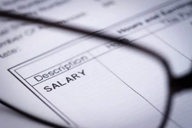 image of a paycheck, with glasses magnifying the word "salary"