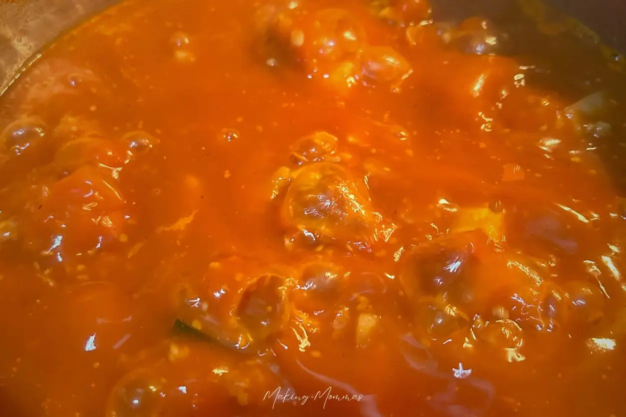 An image of hamburger veggie soup simmering in a pot.