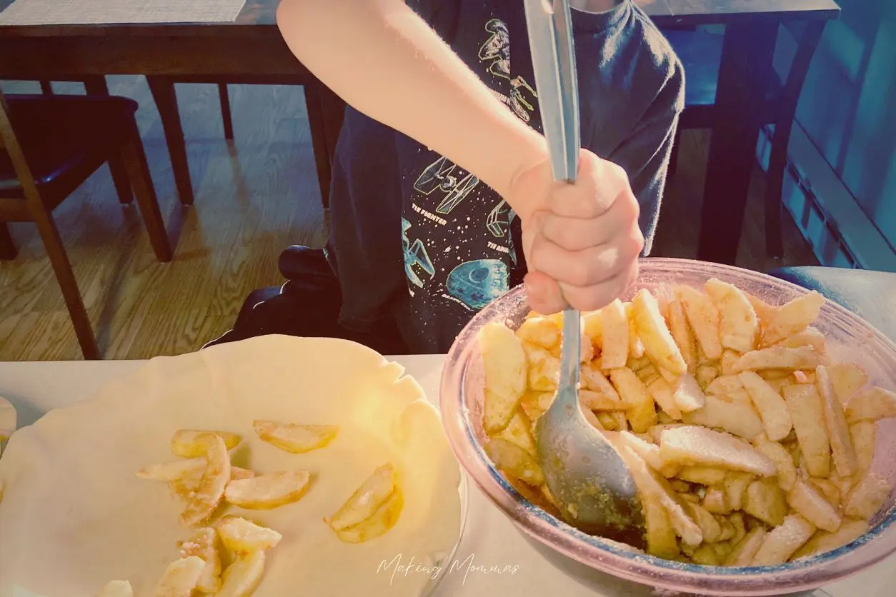 image of a little boy making a pie