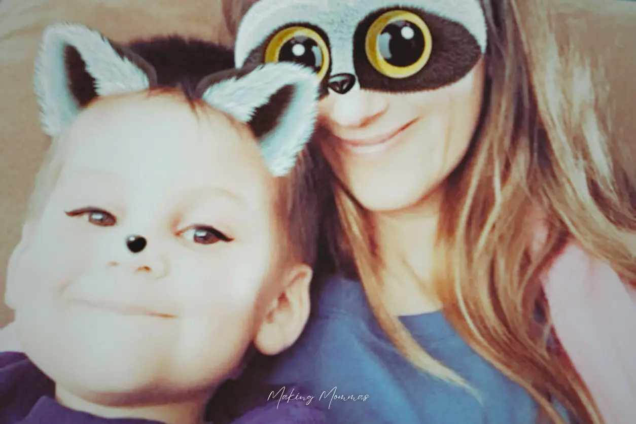 image of a mom and a toddler with racoon faces and ears on