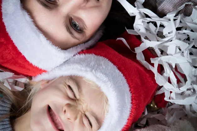 image of mom and kid with Christmas hats on