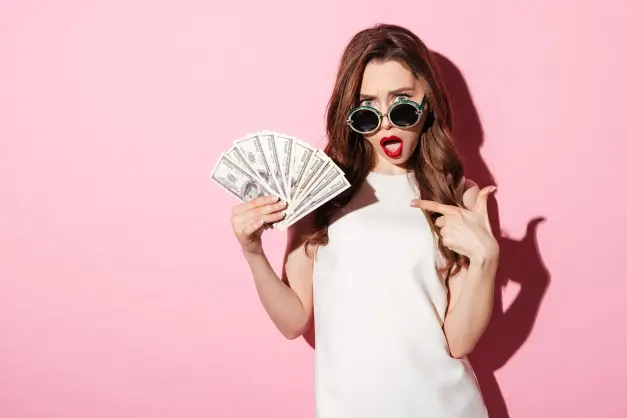 image of a woman with oval sunglasses and bright red lipstick pointing in surprise at a handful of money