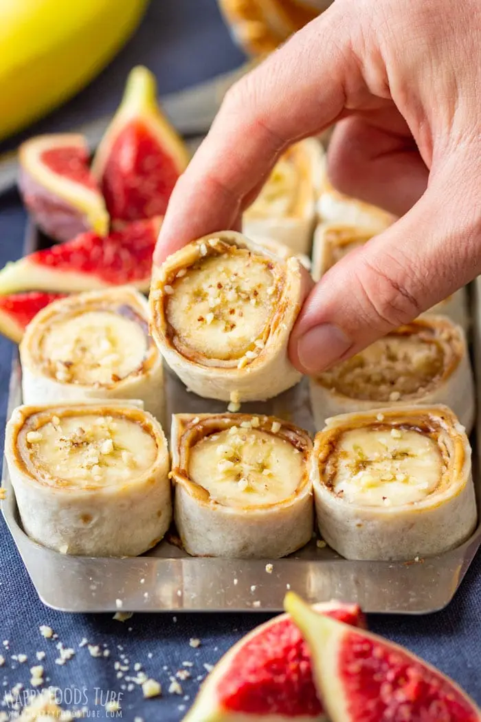 image of peanut banana roll ups in. a tin container