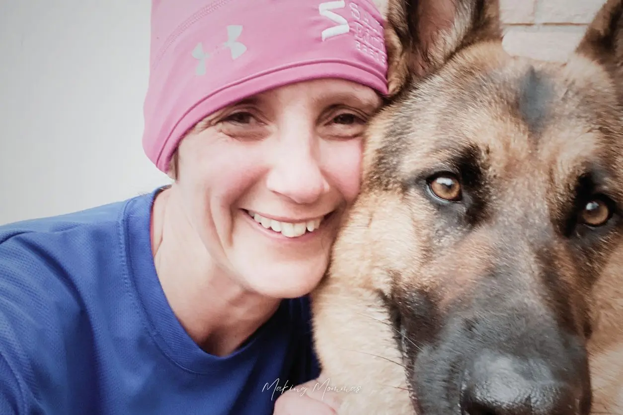 image of a woman holding a german shepherd