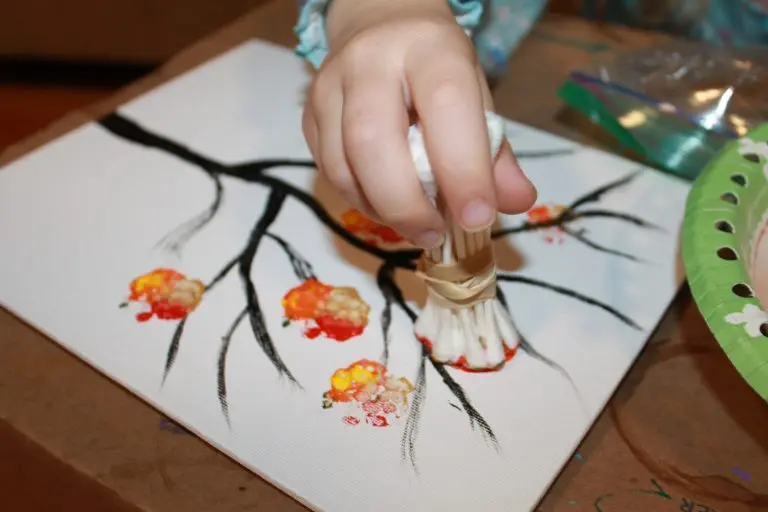 image of a child's hand busy creating a qtip tree