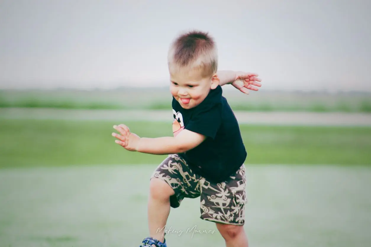image of a little boy running with his tongue sticking out