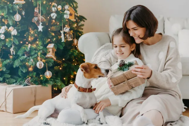A mom, daughter and dog on Christmas