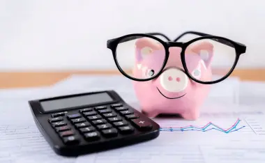 image of pink piggy bank with glasses on