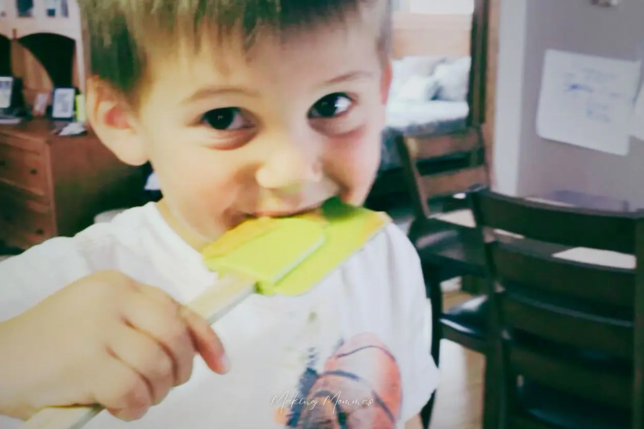 image of a child licking the spatula