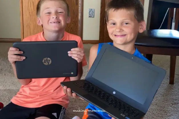 two boys with chrome books