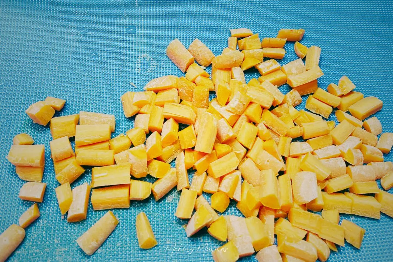 image of chopped carrots on a teal cutting board