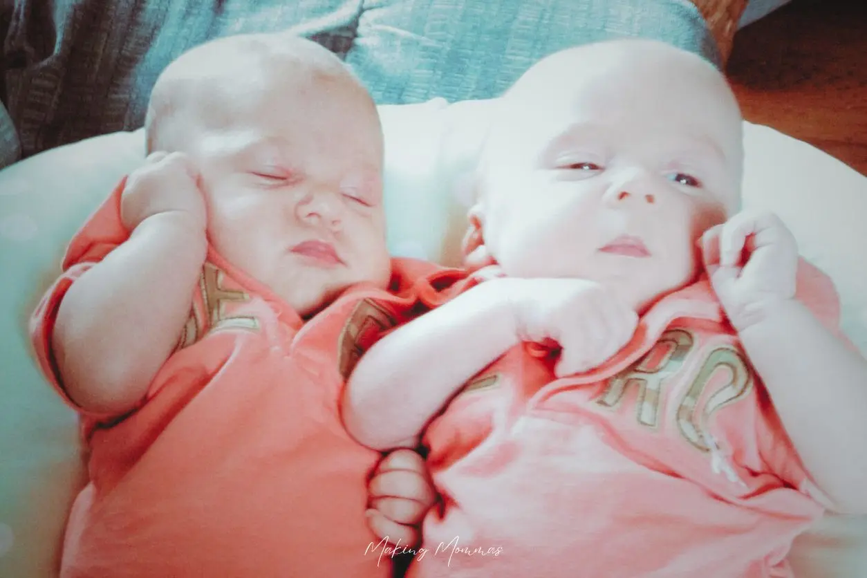 image of twins in matching pink shirts