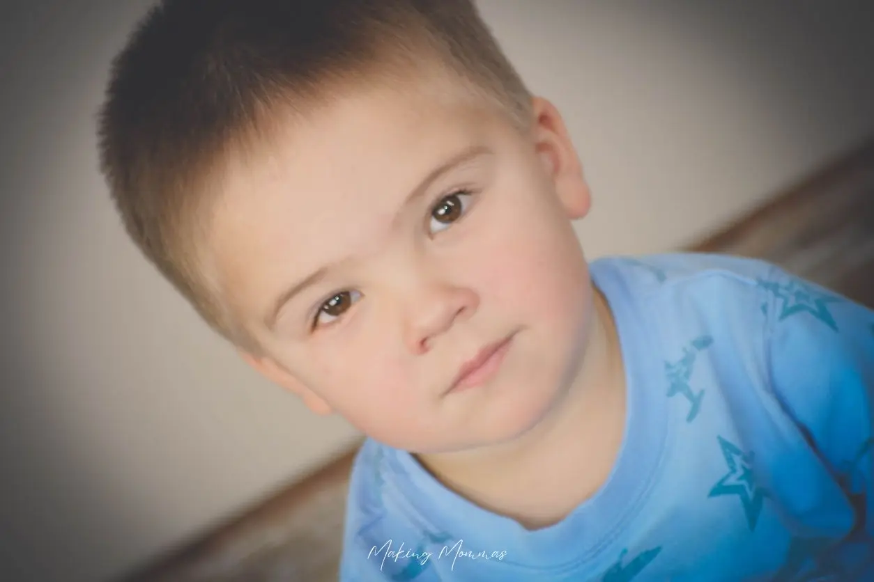 image of a sad little boy in a blue shirt