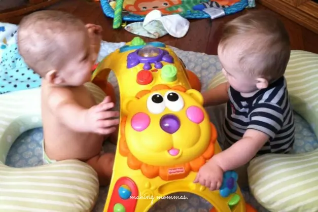 image of twins playing with a toy
