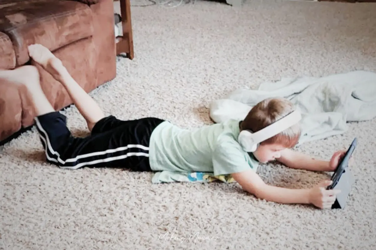 image of a boy watching a screen on the floor